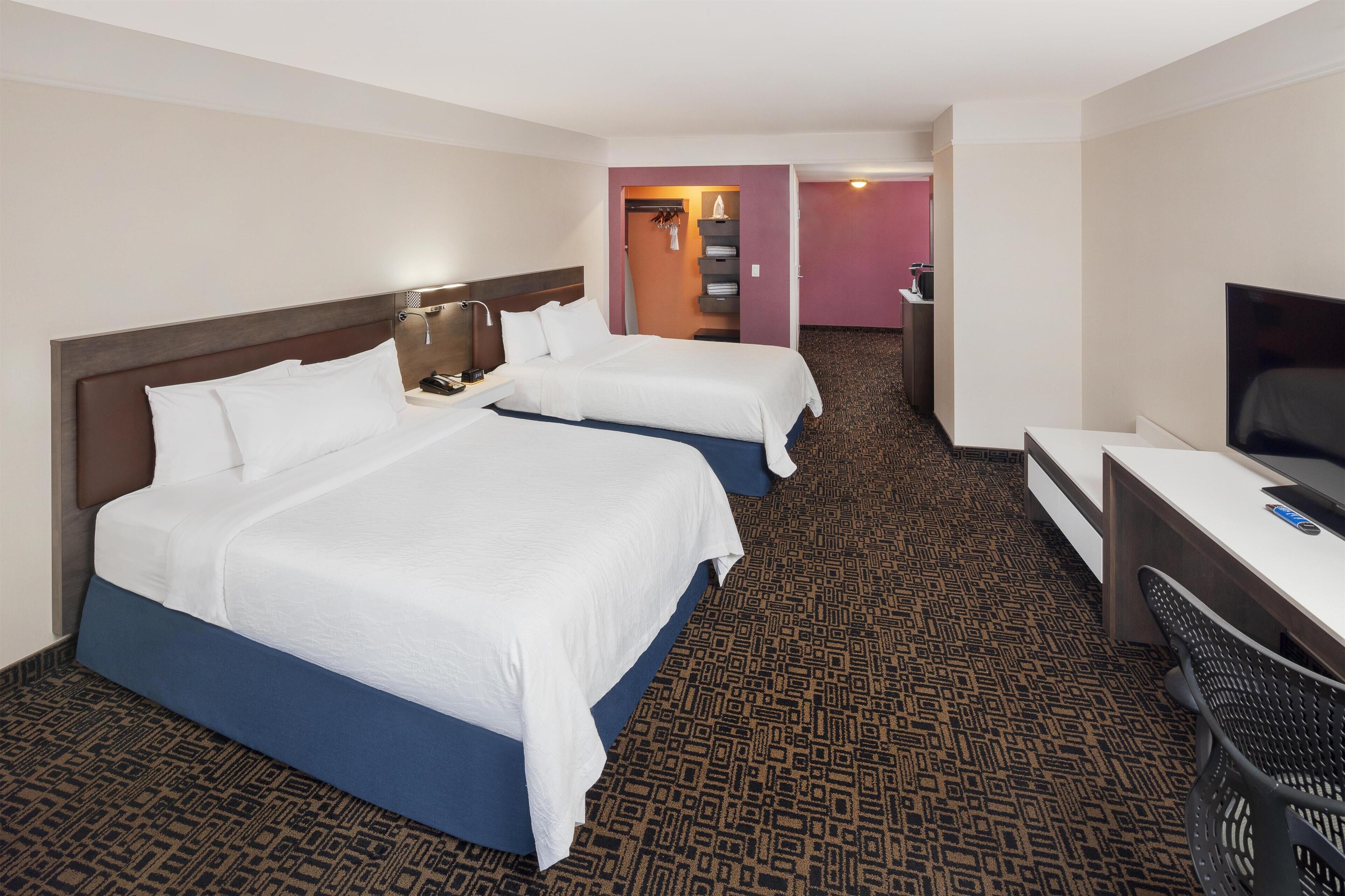 Premium bedding, in-room safe, laptop workspace, soundproofing