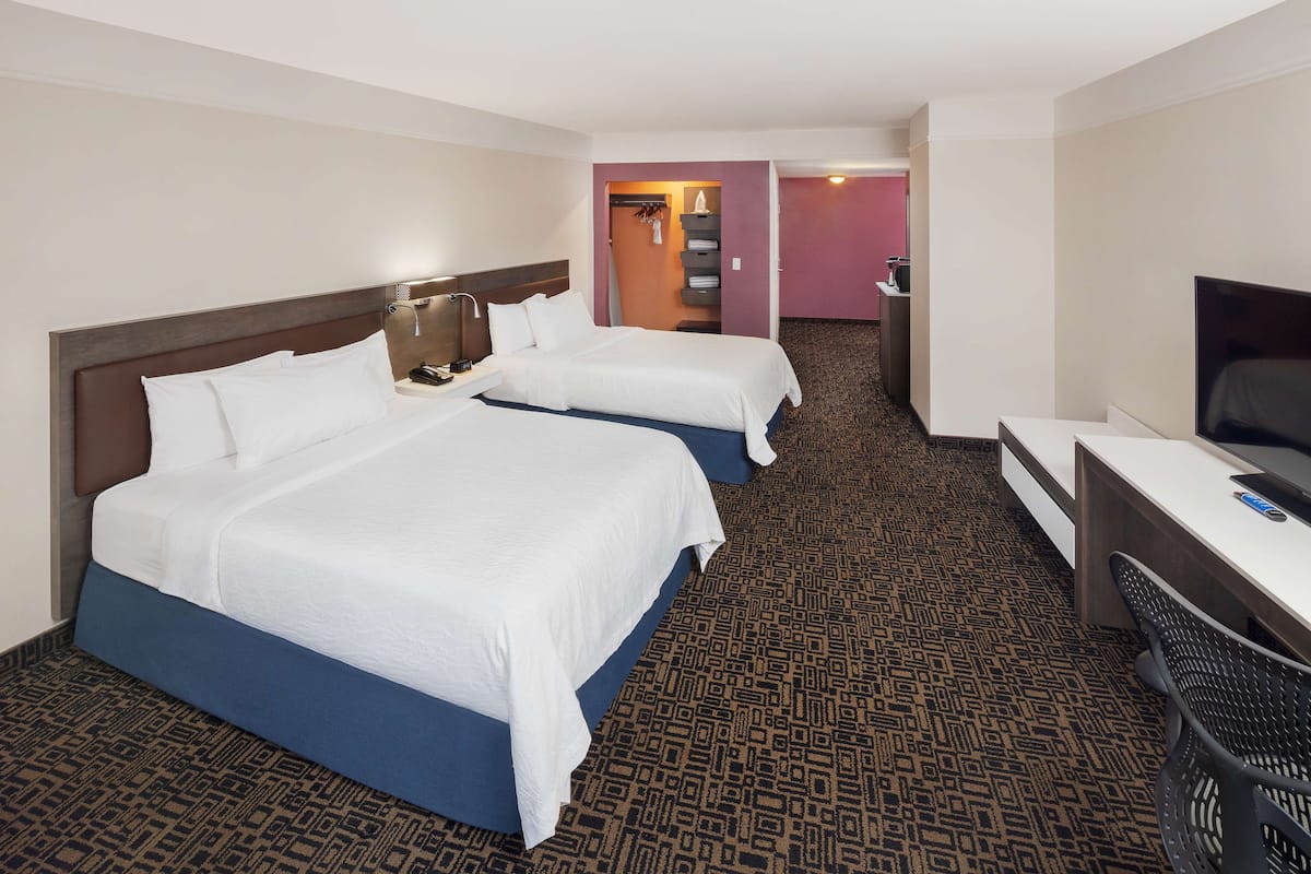 Premium bedding, in-room safe, laptop workspace, soundproofing
