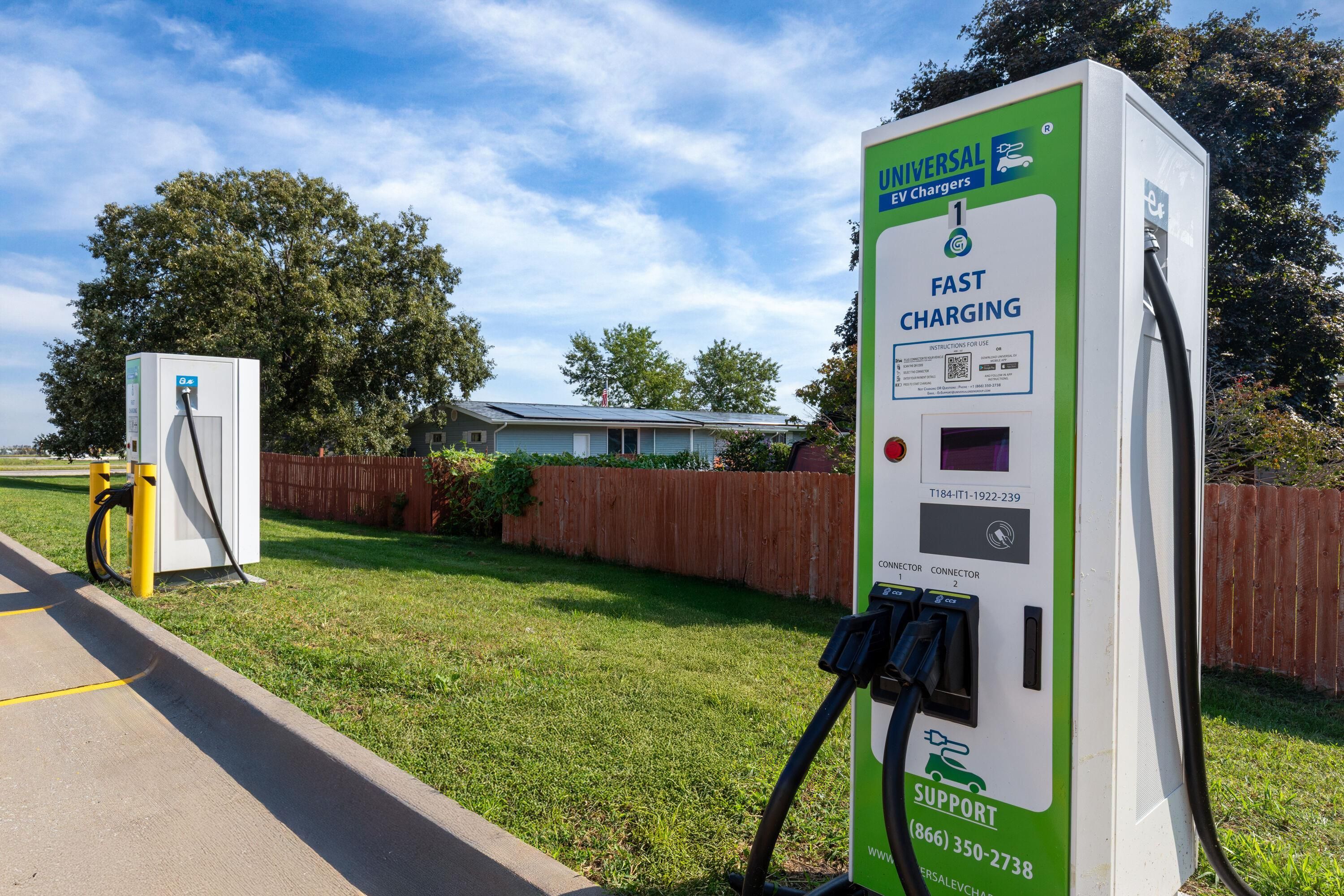 A universal EV charger with a green and white color scheme, labeled 'FAST CHARGING,' and a support phone number.