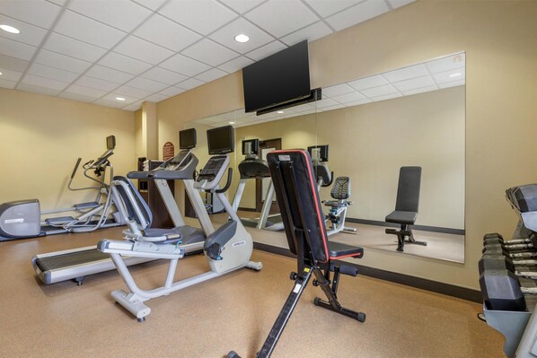 A gym with treadmills, elliptical machines, and weight benches. - Best Western Plus Cimarron Hotel & Suites (Stillwater)