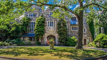Set amidst lush gardens, this historic building boasts an arched entrance and classic design.