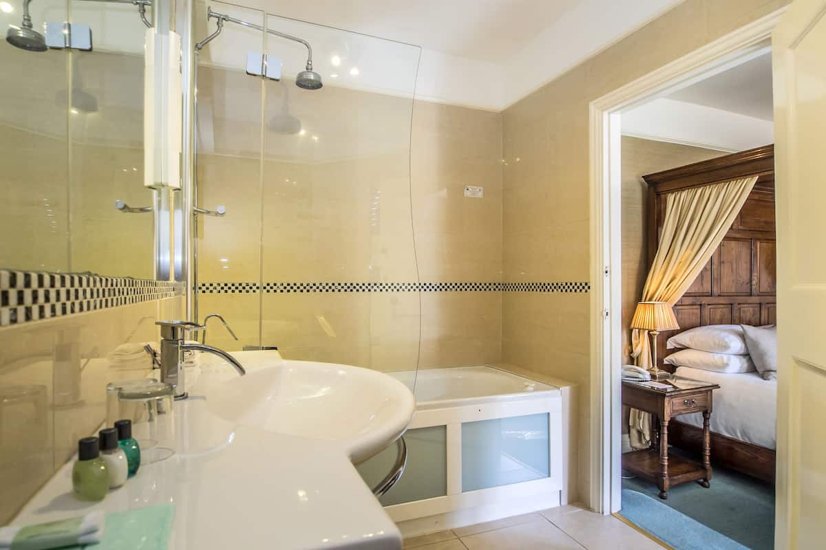 deluxe room, 1 king bed | bathroom | designer toiletries, hair dryer, bathrobes, towels