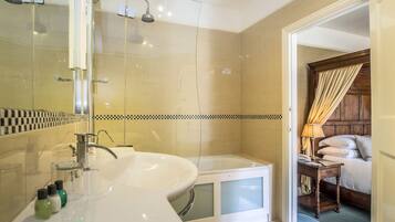 A modern bathroom with a large sink, bathtub, and shower.