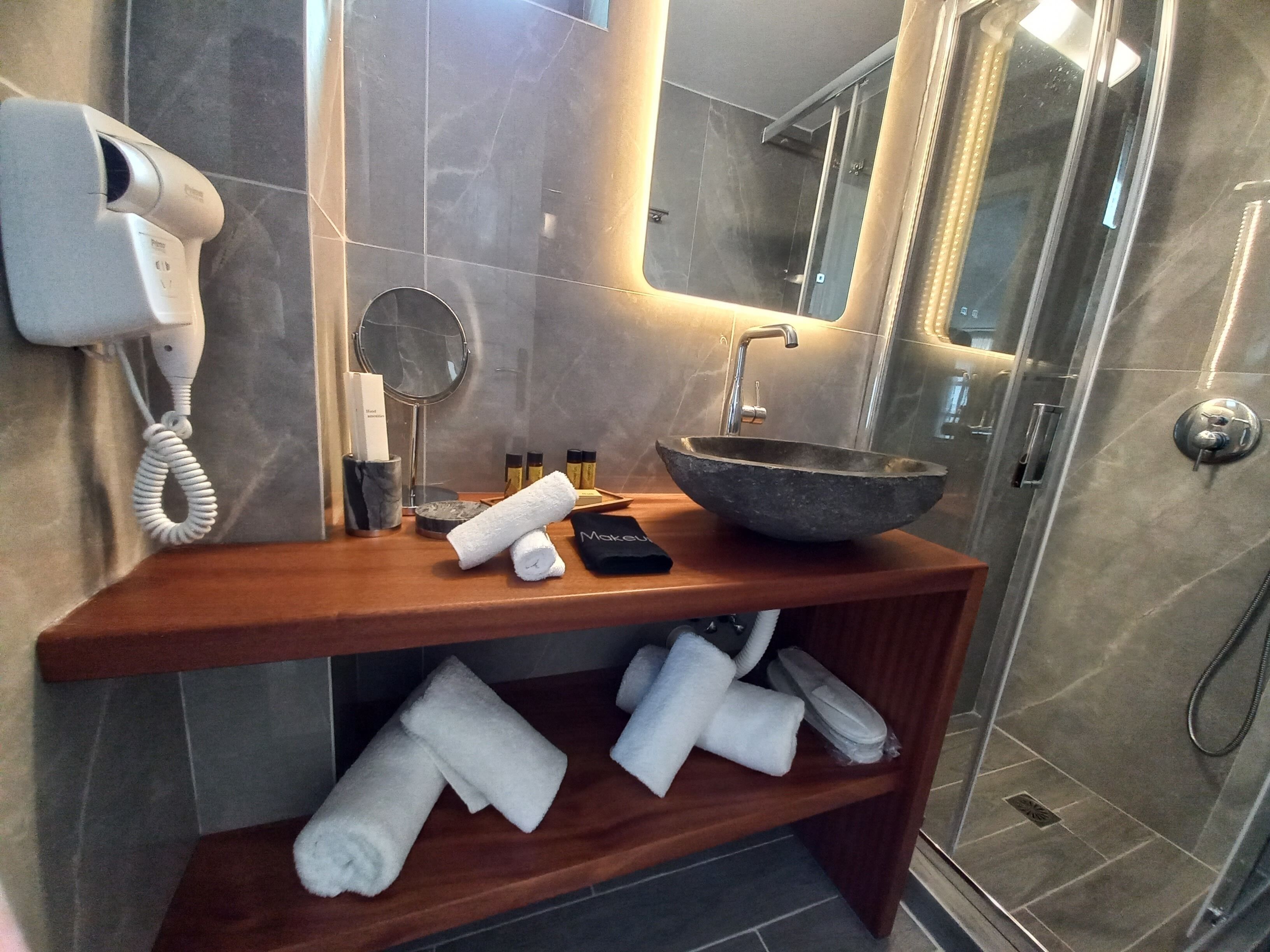 honeymoon suite with outdoor hot tub, sea view | bathroom | shower, free toiletries, hair dryer, bathrobes