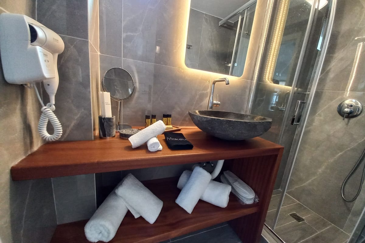 honeymoon suite with outdoor hot tub, sea view | bathroom | shower, free toiletries, hair dryer, bathrobes