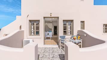 Enjoy a room with a large window offering a view of the sky, a seating area, and a kitchenette.