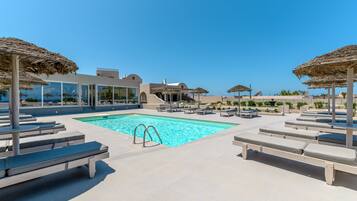 Seasonal outdoor pool, open 10:00 AM to 9:00 PM, pool umbrellas