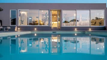 Seasonal outdoor pool, open 10:00 AM to 8:00 PM, pool umbrellas