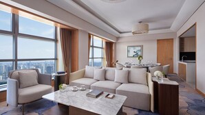 A modern hotel room with a large window, a sofa, a coffee table, and a dining area. - Ningbo Marriott Hotel (Ningbo)