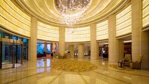 A spacious lobby with a large chandelier, a central circular carpet, and a reception desk. - Ningbo Marriott Hotel (Ningbo)