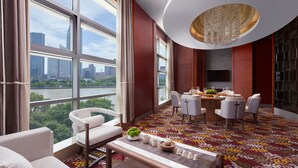 A modern hotel room with large windows, a dining area, and a chandelier. - Ningbo Marriott Hotel (Ningbo)