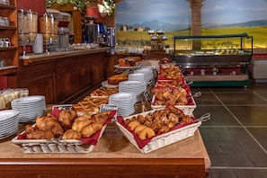 Indulge in a spread of pastries, baked goods, and more at this beautifully set buffet.