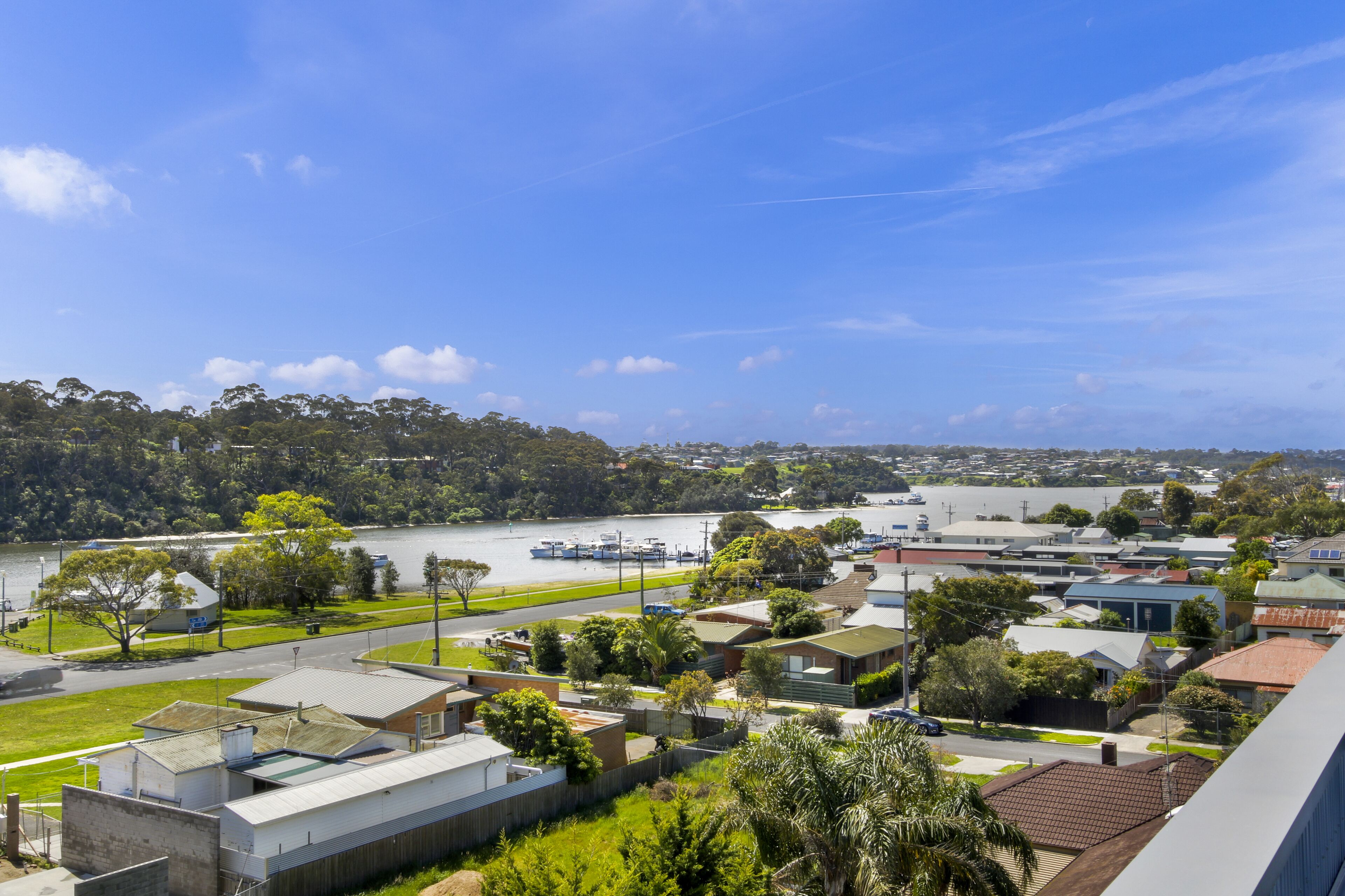 A residential area with houses, a road, and a river.