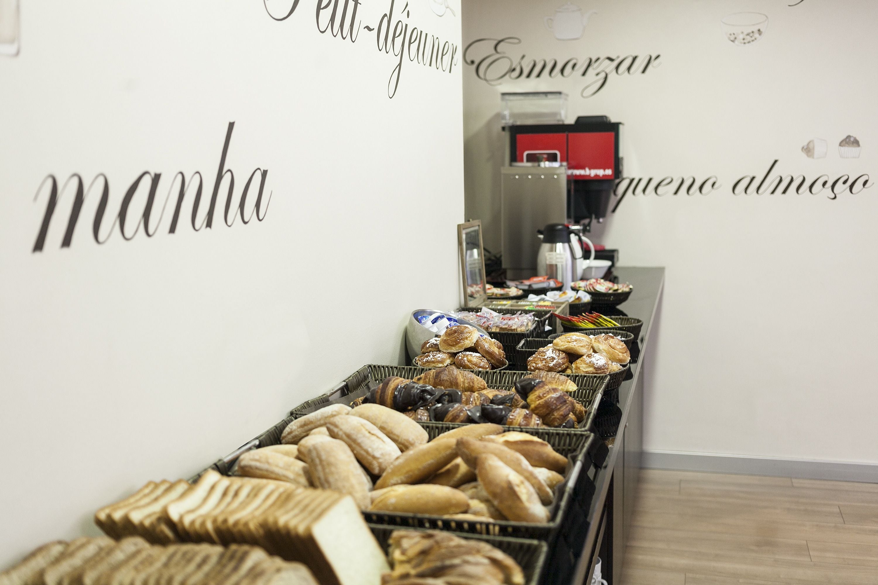 A bakery display with various breads and pastries.