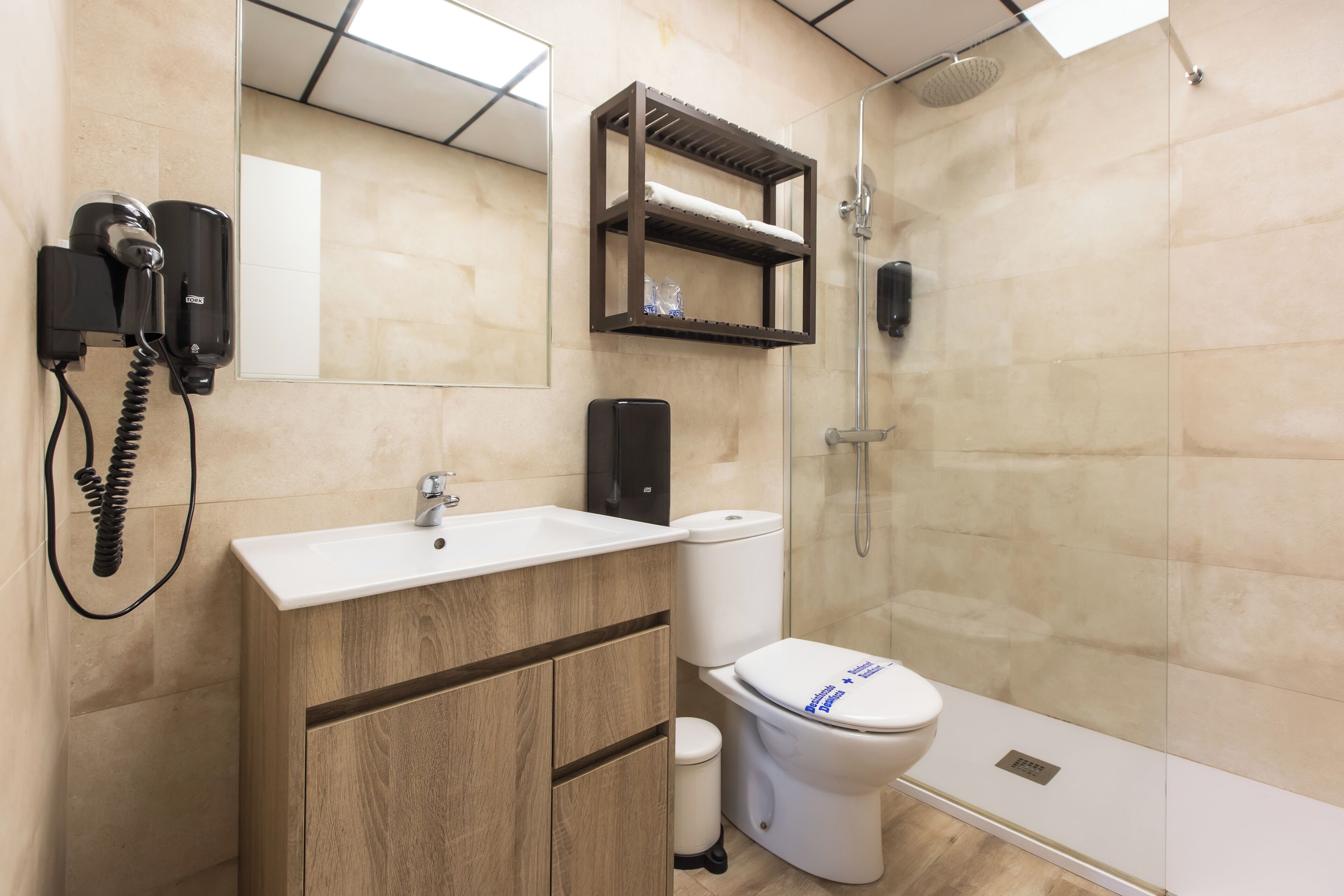 A modern bathroom with a sink, toilet, and shower.
