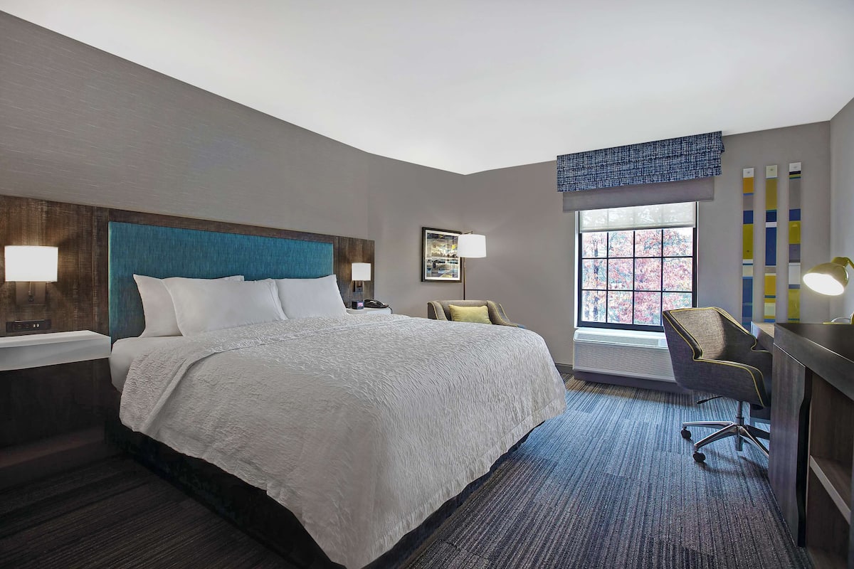 Premium bedding, desk, laptop workspace, blackout drapes