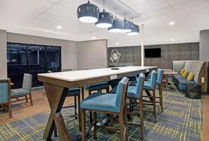 A modern meeting room with a long table, blue upholstered chairs, and a patterned carpet. - Hampton Inn Westfield (Westfield)