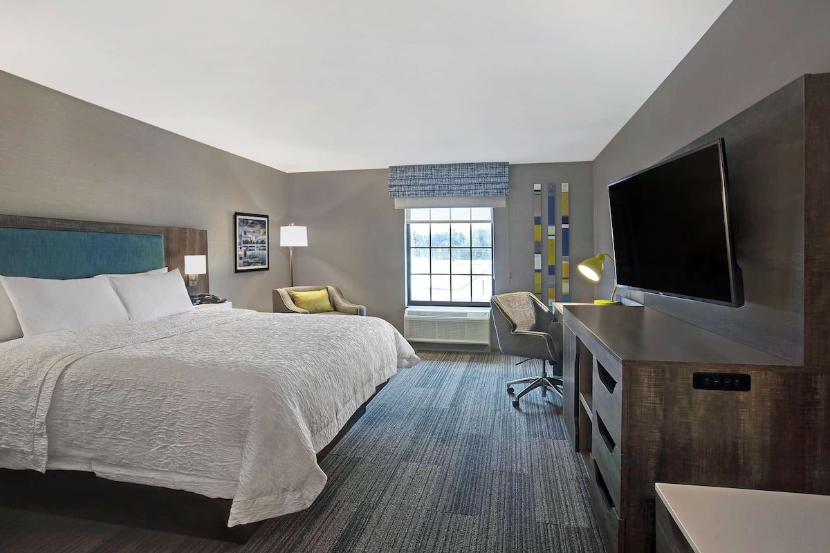 Premium bedding, desk, laptop workspace, blackout drapes