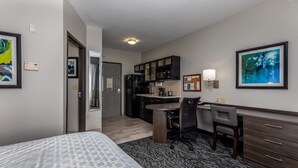 A hotel room with a bed, a desk, a chair, a kitchenette, and a bathroom. - Candlewood Suites Knoxville Airport-Alcoa by IHG (Alcoa)