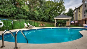 A swimming pool with lounge chairs and a gazebo. - Candlewood Suites Knoxville Airport-Alcoa by IHG (Alcoa)
