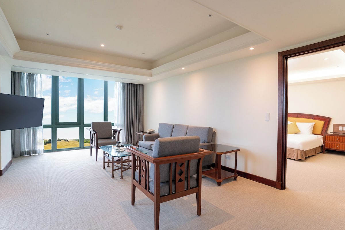 deluxe suite, 1 king bed | living room | tv