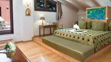 A bedroom with a bed, a desk, a chair, a window, and a painting.