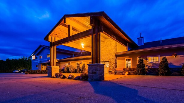 A large, modern house with a prominent wooden structure and stone foundation. - Best Western Plus Ticonderoga Inn & Suites (Ticonderoga)