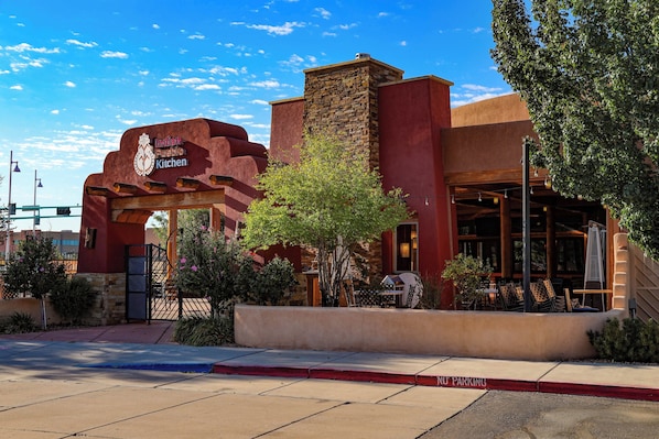 A building with a stone facade and a sign reading "Indian Pueblo Kitchen."