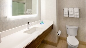 A modern bathroom with a large mirror, white sink, and toilet. - Holiday Inn Express Los Angeles Airport Hawthorne by IHG (Hawthorne)