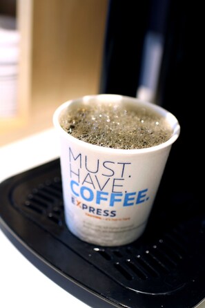 A coffee cup on a black tray with the text "MUST HAVE COFFEE EXPRESS". - Holiday Inn Express Los Angeles Airport Hawthorne by IHG (Hawthorne)