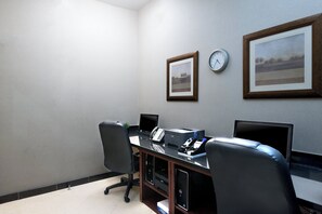 A conference room with a desk, chairs, a clock, and framed pictures on the wall. - Holiday Inn Express Los Angeles Airport Hawthorne by IHG (Hawthorne)