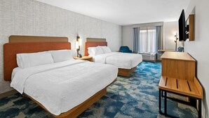 A hotel room with two beds, a desk, a chair, a TV, and a window with curtains. - Hampton Inn Harrison (Harrison)