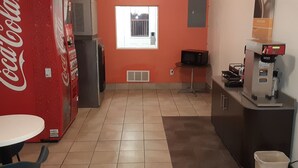 A compact kitchen with a refrigerator, microwave, and coffee machine. - Motel 6 Goodland, KS (Goodland)