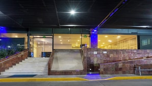 A modern building entrance with a staircase leading to an interior area. - Holiday Inn Express Mexico Santa Fe by IHG (Mexico City)