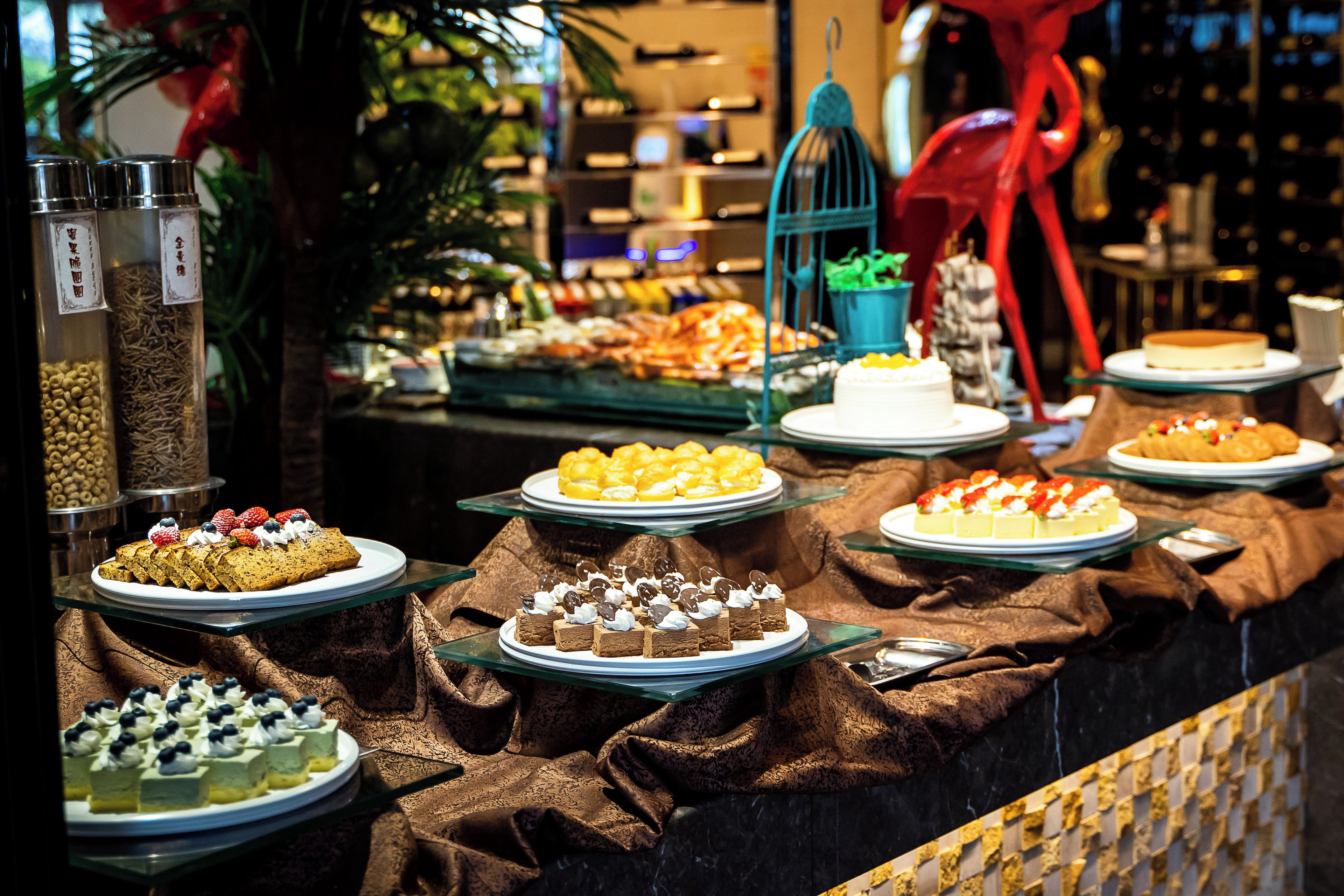 A buffet with various food items and a cake on display.