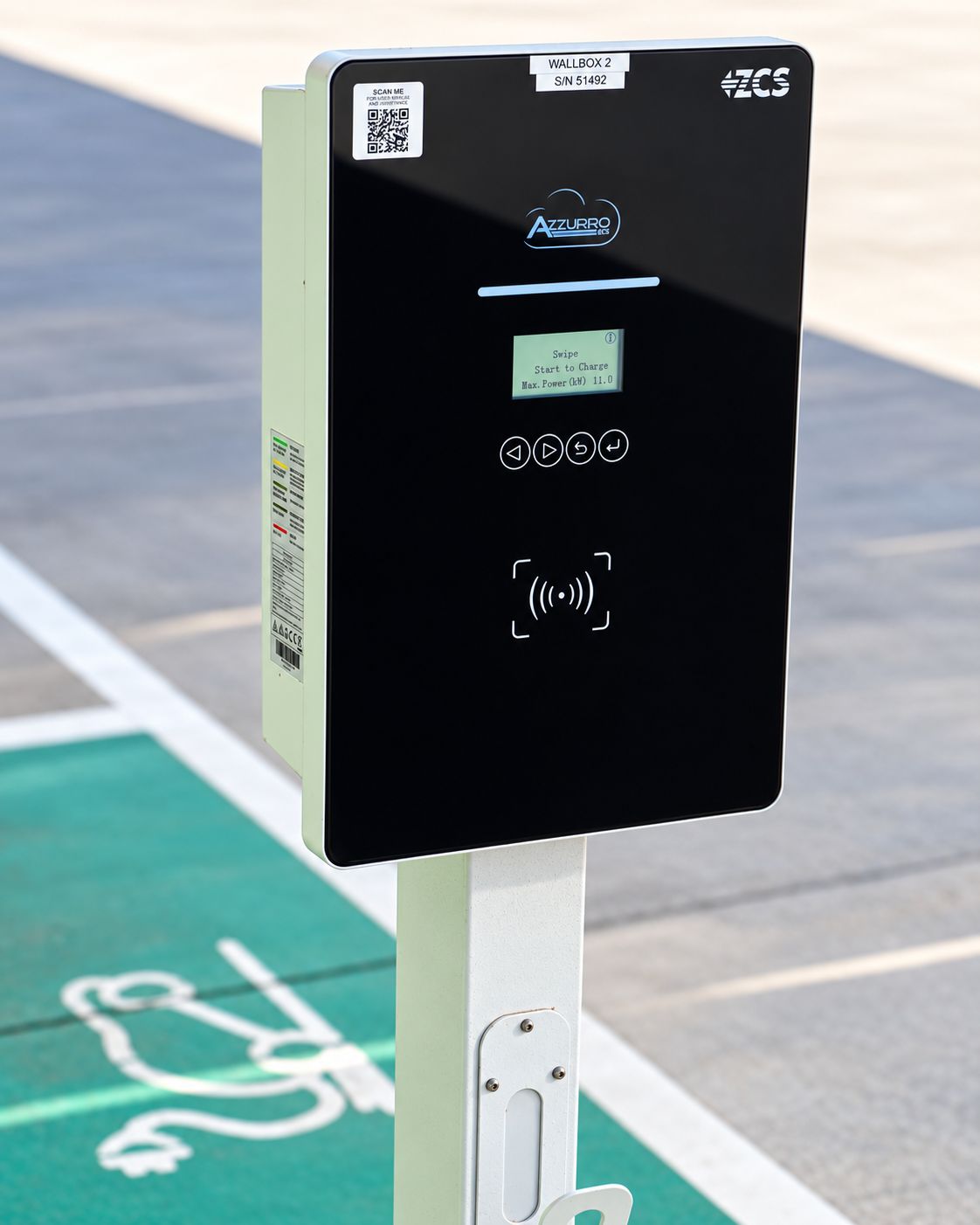 A black electronic device with a QR code, a label reading 'WALLBOX 2 S/N 51492', and the 'AZZURRO' logo.
