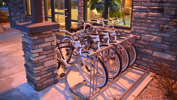 Un edificio de piedra con un aparcamiento para bicicletas afuera.