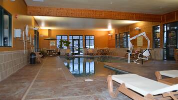 Een binnenzwembad en ligstoelen