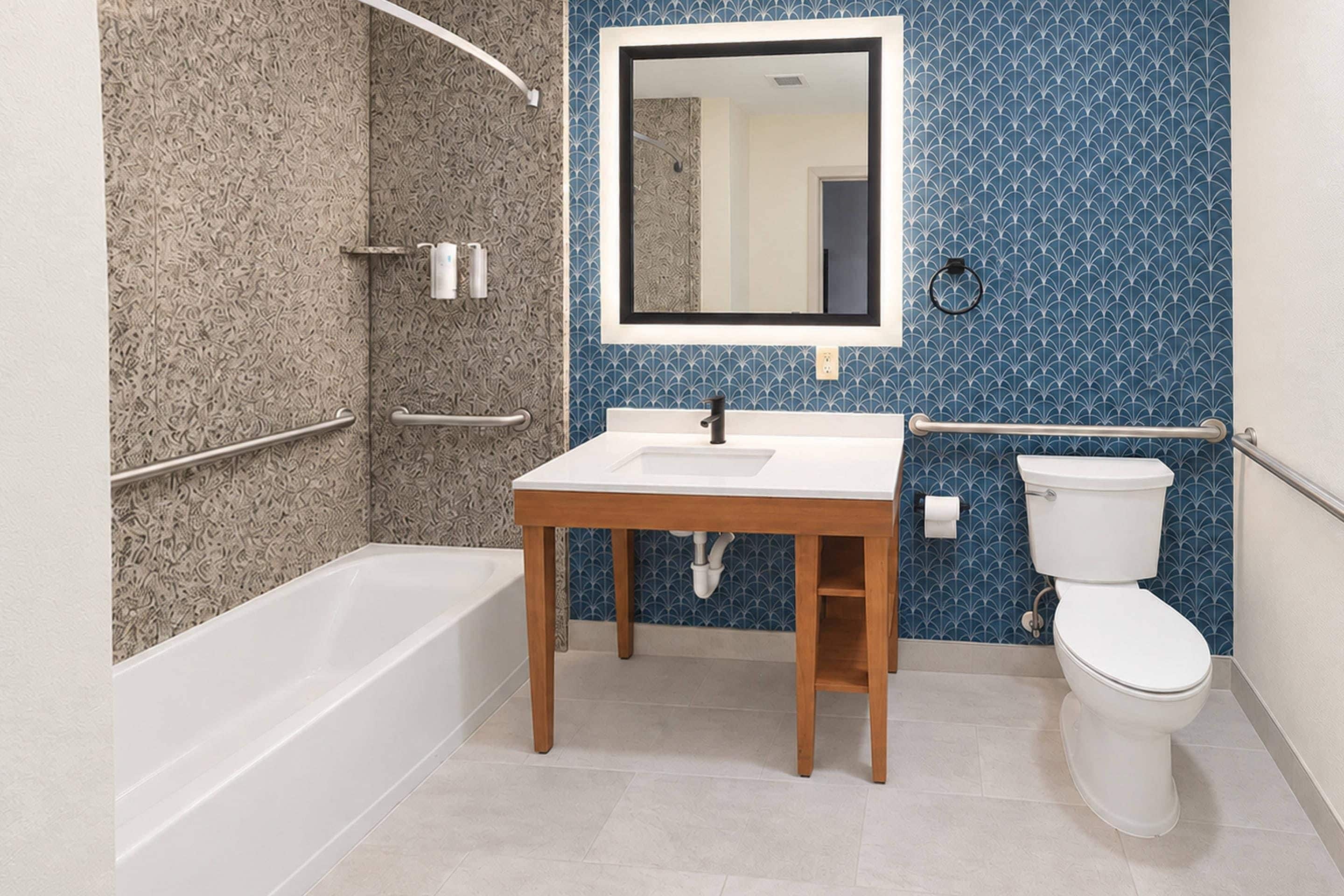 A bathroom with a bathtub, sink, and toilet.