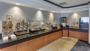 A buffet setup with various food items and a self-service station. - Country Inn & Suites by Radisson, Pensacola West, FL (Pensacola)