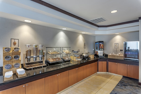A buffet setup with various food items and a self-service station. - Country Inn & Suites by Radisson, Pensacola West, FL (Pensacola)