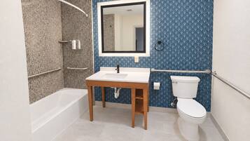 A bathroom with a bathtub, sink, and toilet.