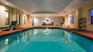 An indoor swimming pool with clear blue water, lounge chairs, and a mural of a diver. - Country Inn & Suites by Radisson, Pensacola West, FL (Pensacola)