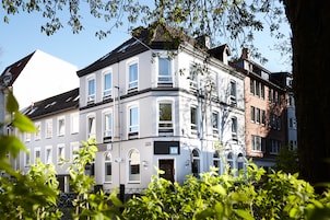A multi-story building with a classic architectural style, featuring large windows and a prominent entrance.