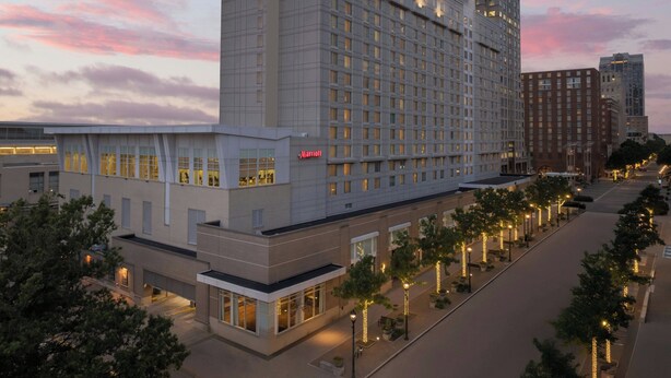 A Marriott hotel with a modern design, featuring a large building with multiple floors and a prominent sign.