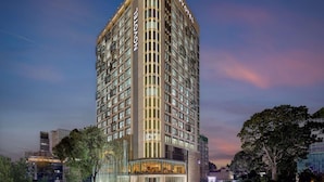 A high-rise hotel with a modern design, featuring multiple floors and a prominent "NOVOTEL" sign.