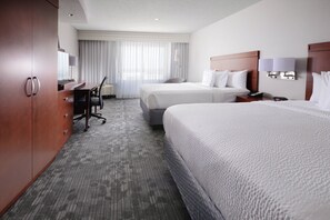 A hotel room with two beds, a desk, and a chair. - Courtyard by Marriott Houston Pearland (Pearland)