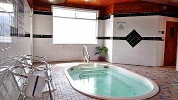 Relax by the pool, surrounded by a beautiful tile pattern and lush greenery.