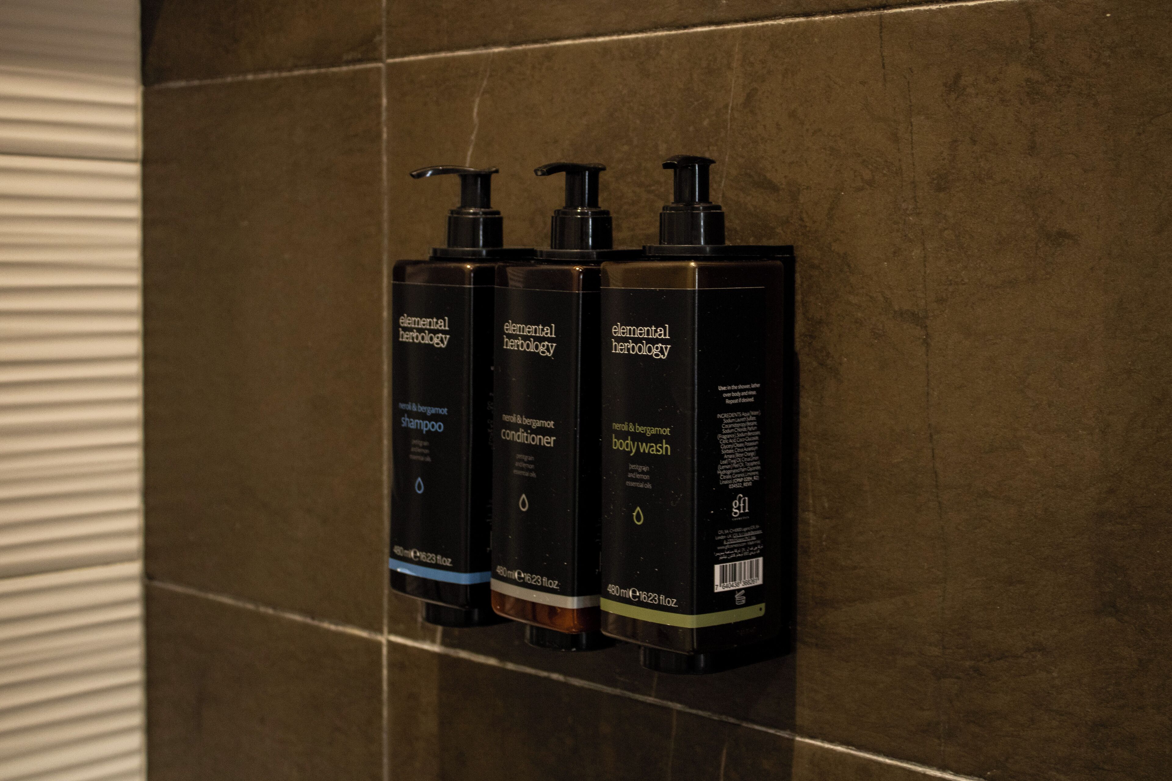 Three Elemental Herbology products on a tiled wall.
