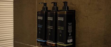 Three Elemental Herbology products on a tiled wall.